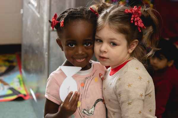 Two preschool friends with their artwork