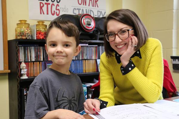 A preschool student with his teacher