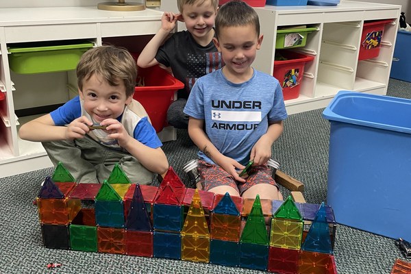 Preschool students build with magnetic tiles