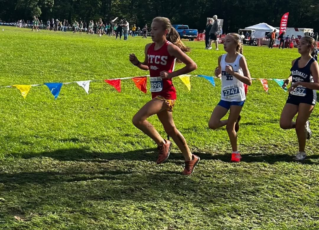 An RTCS runner racing at a 2026 cross country meet